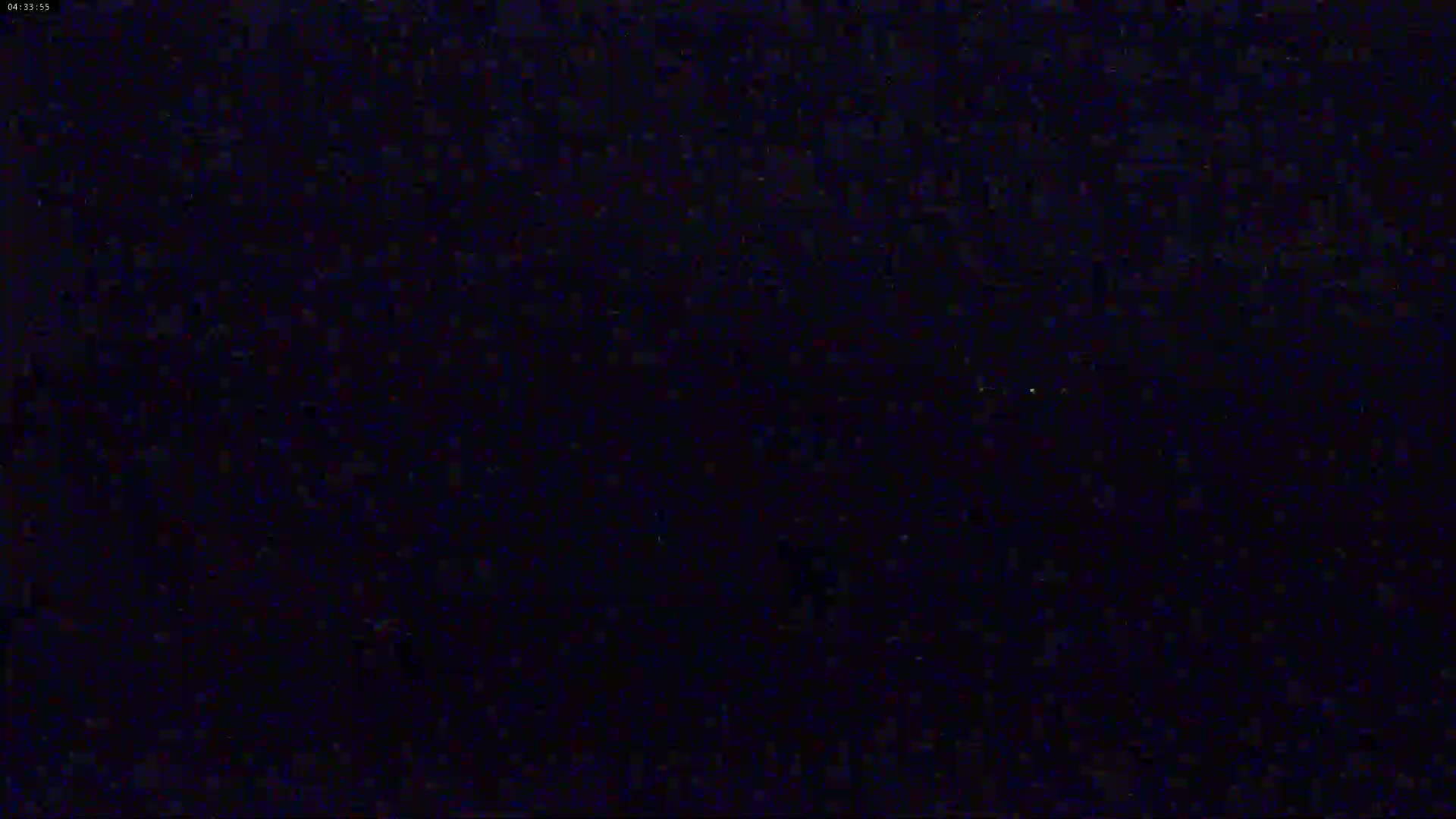 The image shows a dark, possibly nighttime scene with a grainy texture.