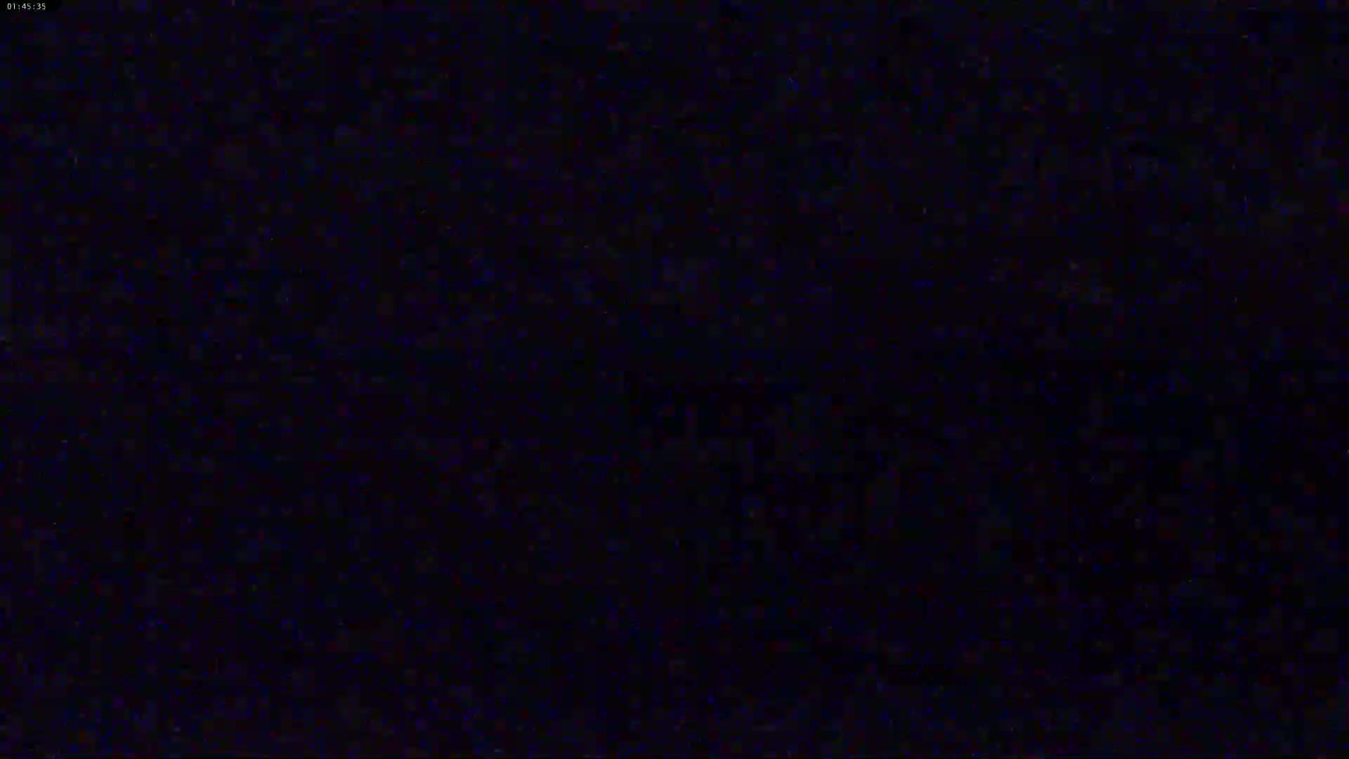 The image is a completely dark, grainy screen.