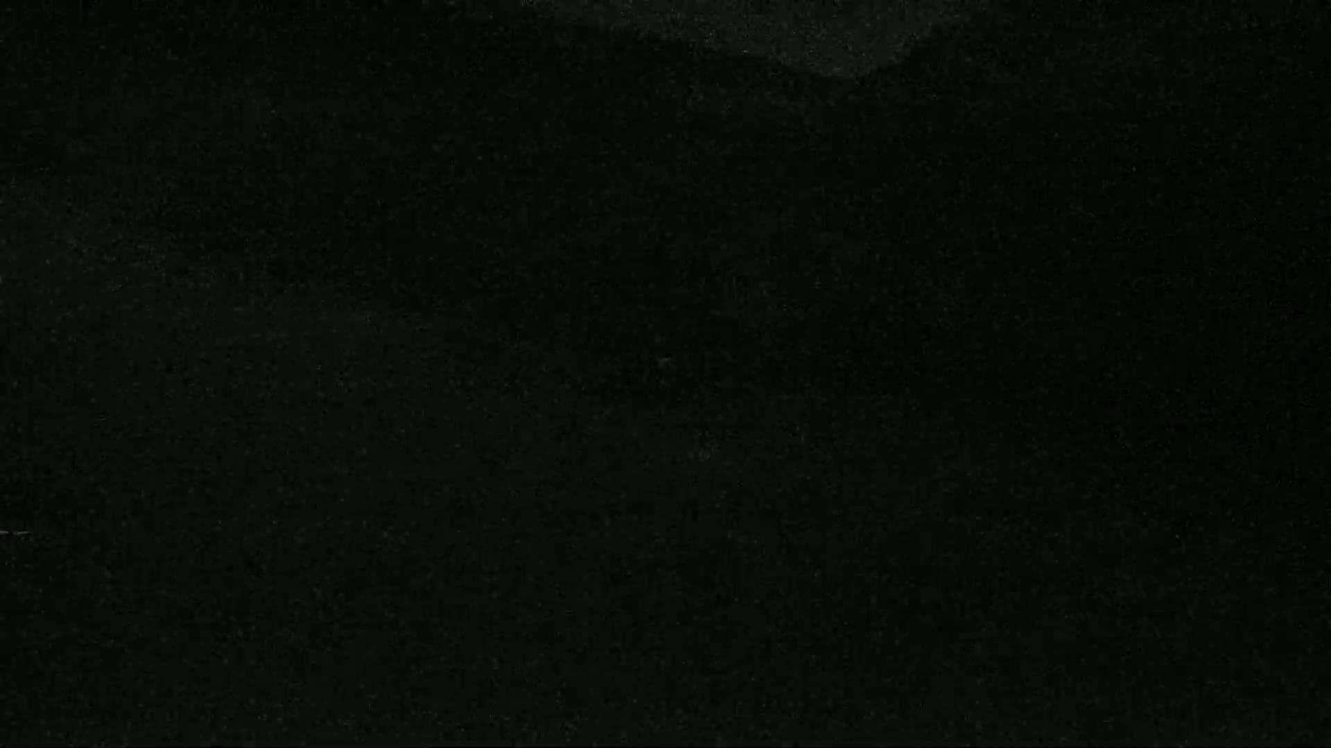 The image shows a completely dark, textured surface.