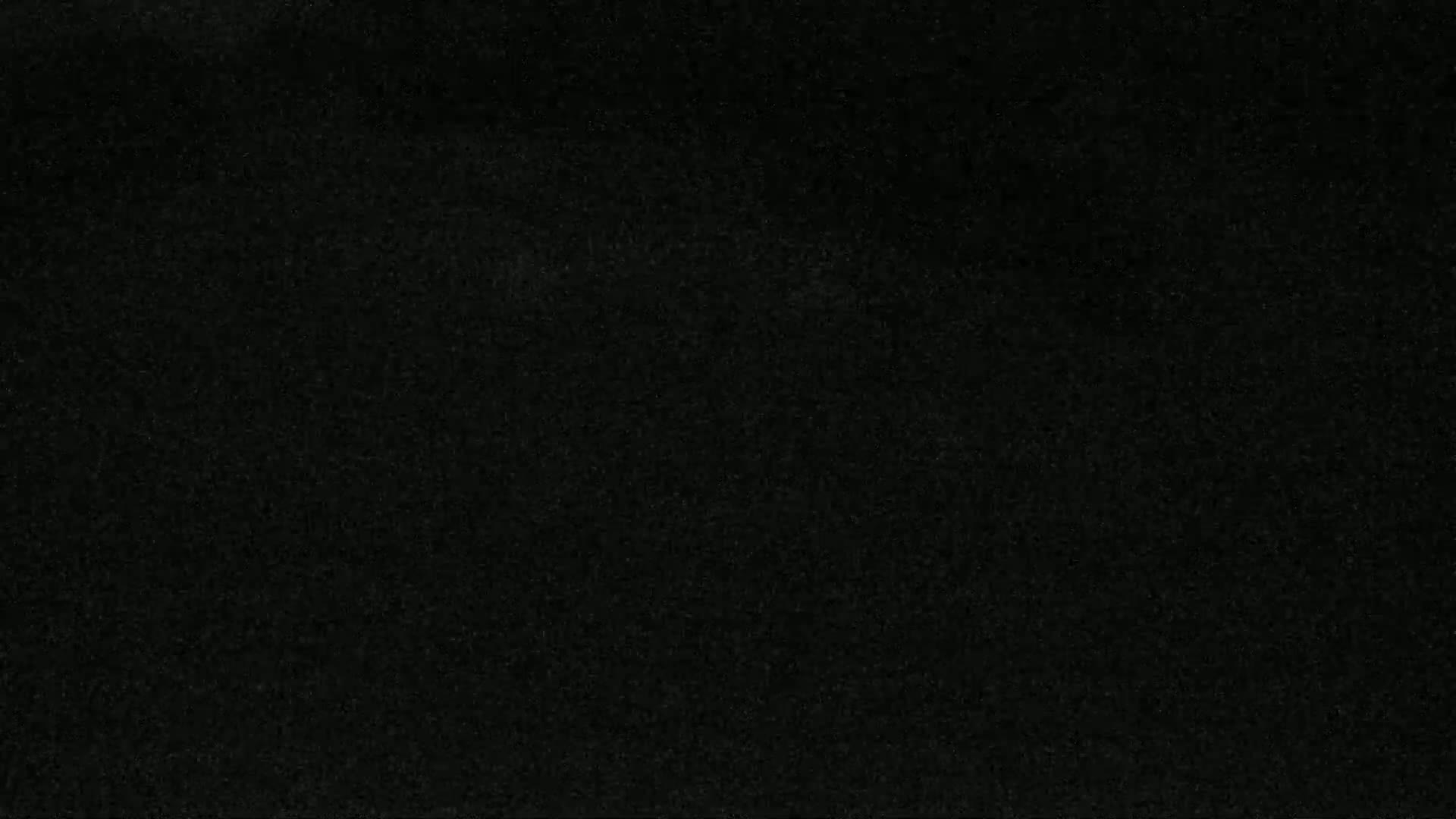 The image shows a dark, textured surface.