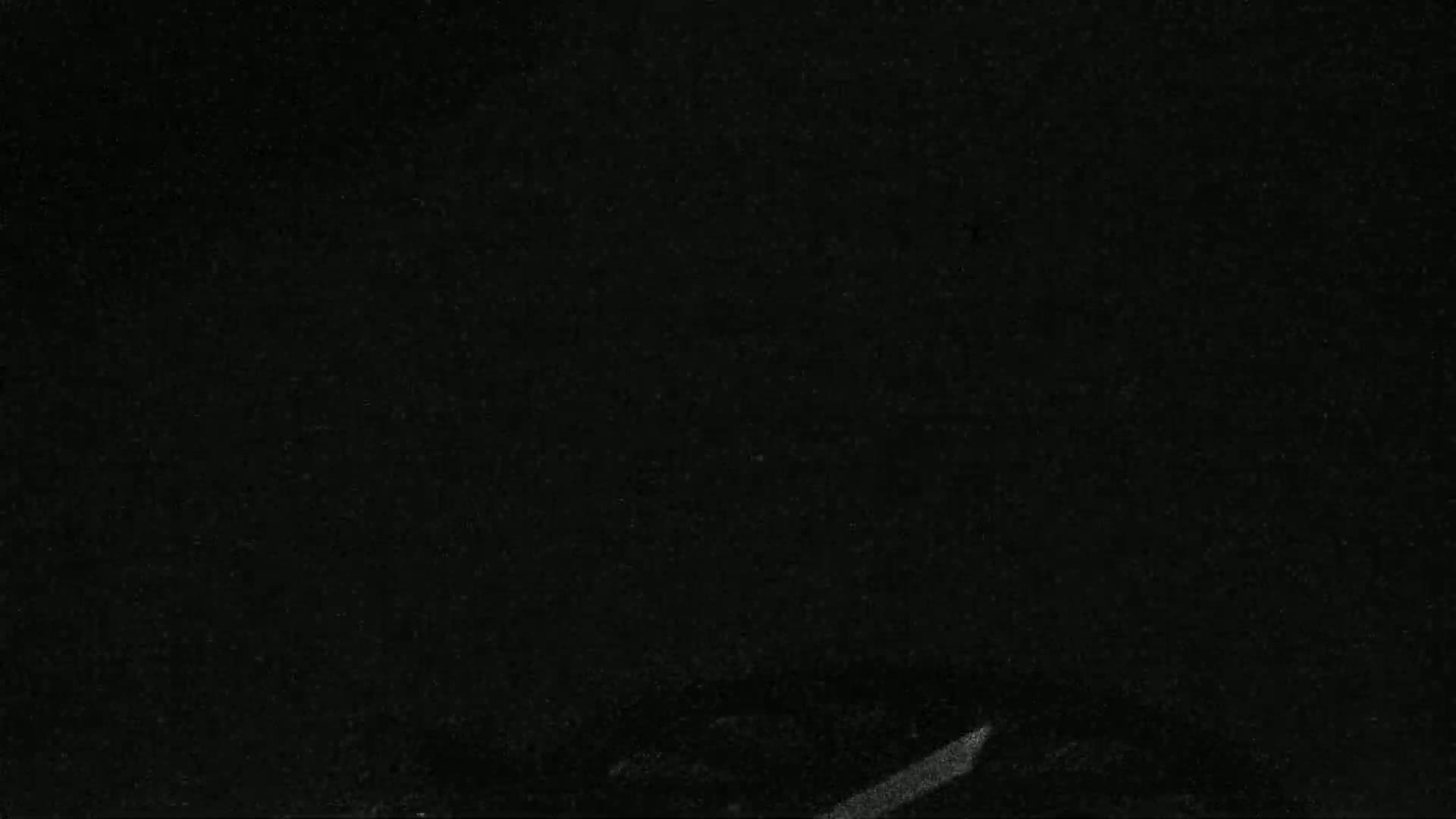 A mostly black image with a faint, lighter gray streak near the bottom.