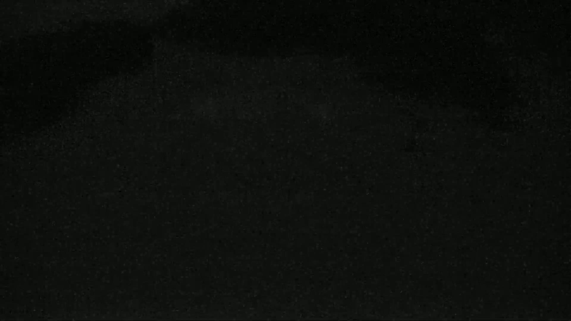 The image shows a dark, speckled surface.