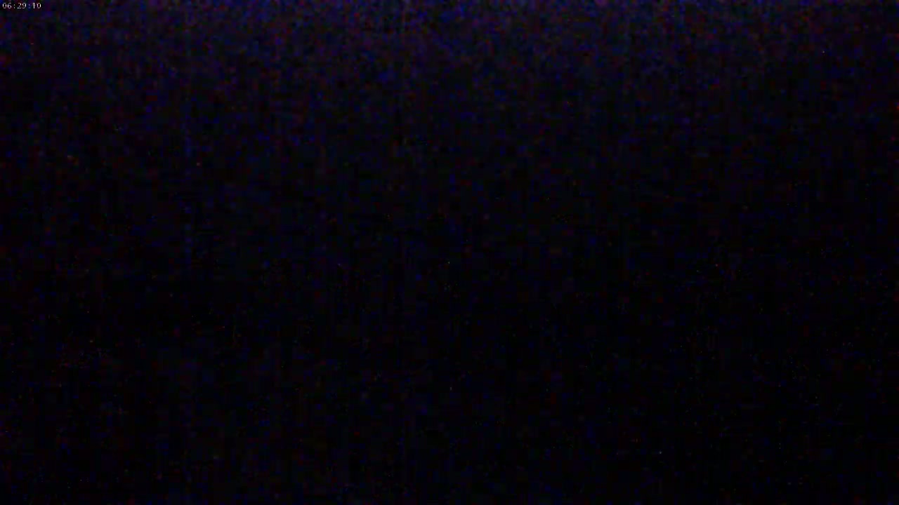 The image is a completely dark, grainy field.