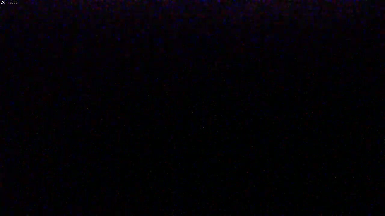 The image shows a completely dark scene with subtle noise and grain.