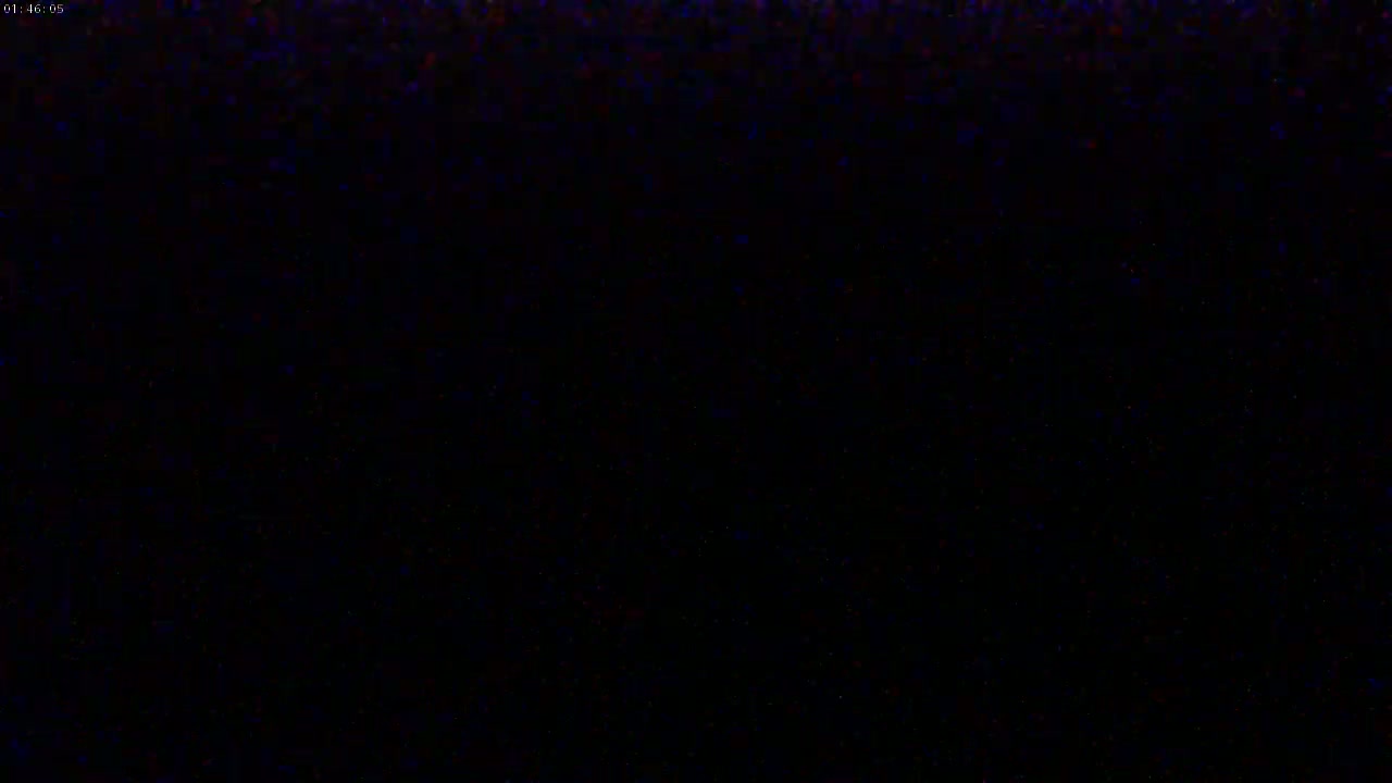 The image is a mostly black screen with a few scattered specks of color.