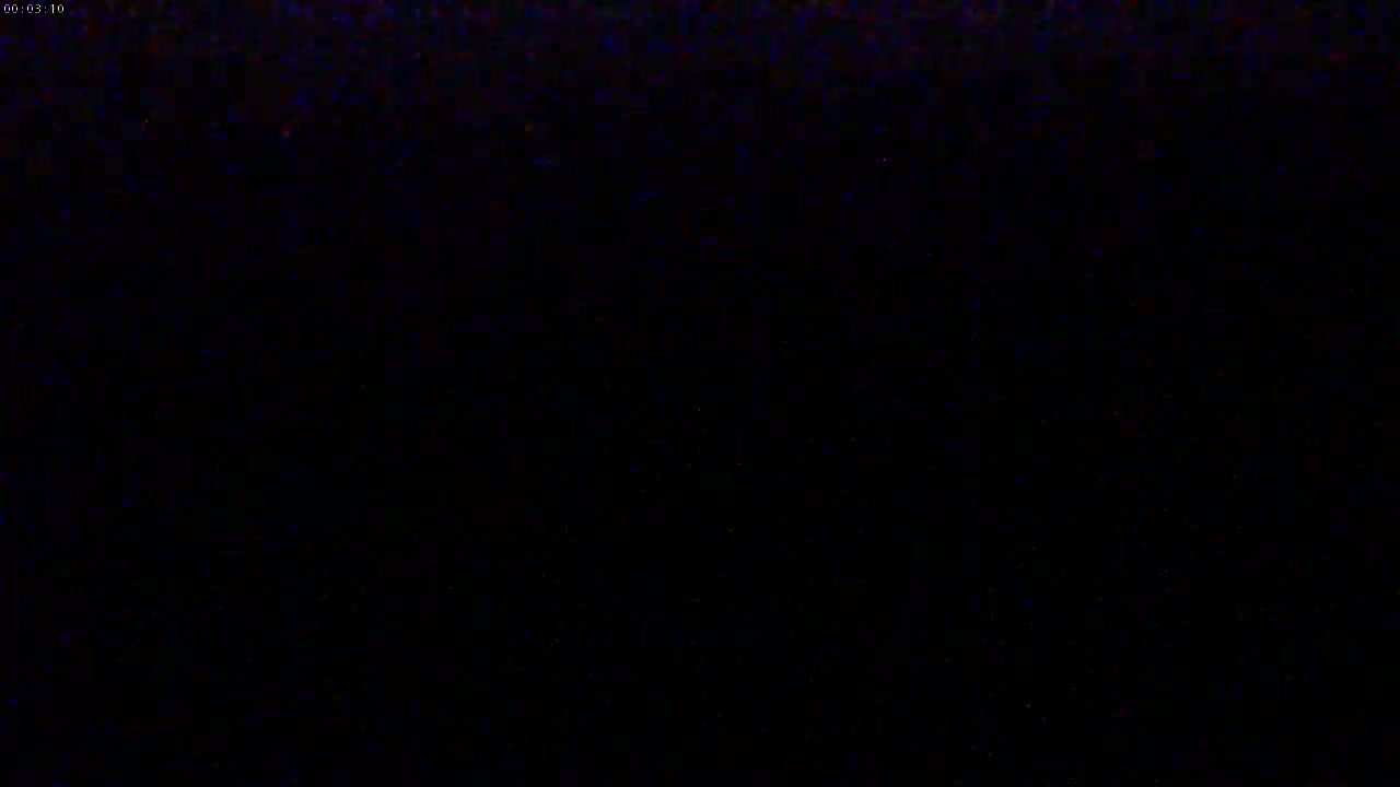 The image shows a mostly black screen with a few specks of color.