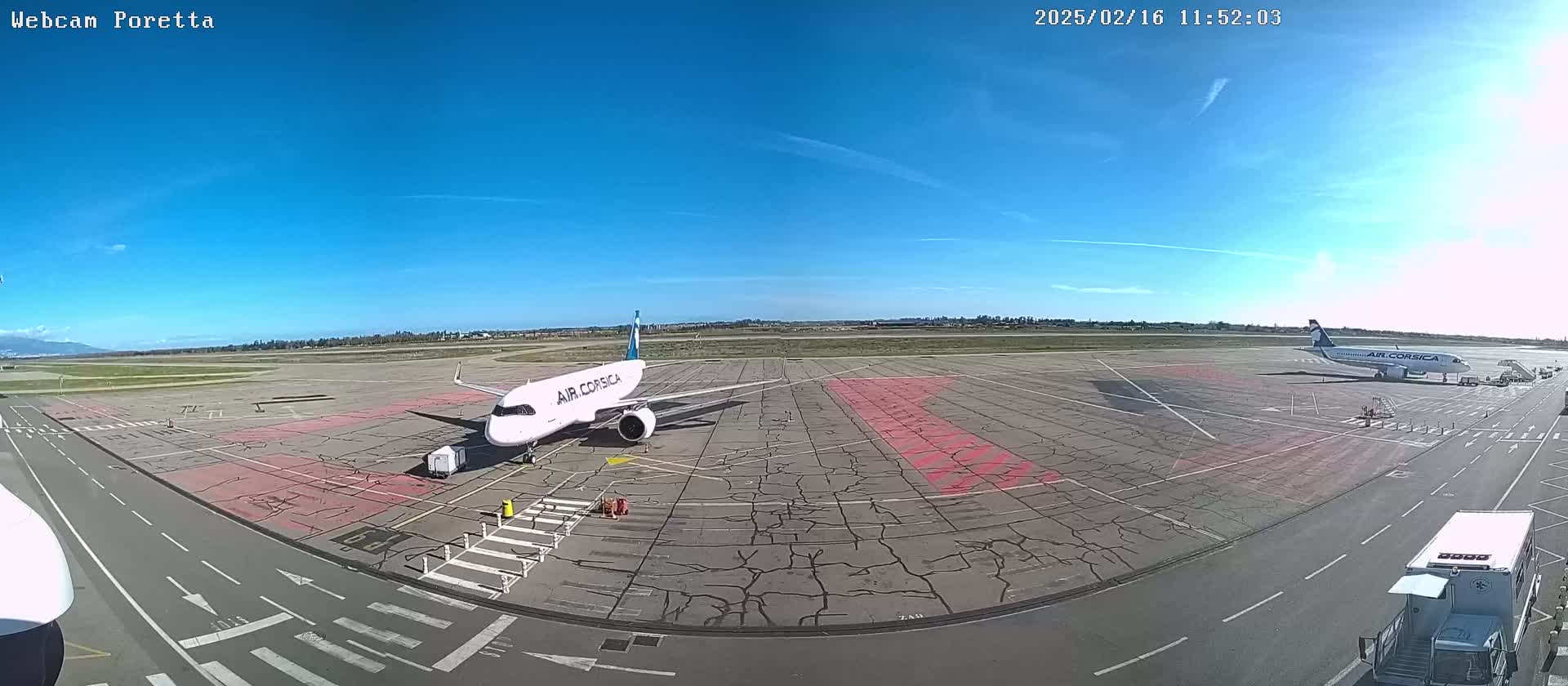 Two Air Corsica airplanes are parked on a tarmac on a sunny day.