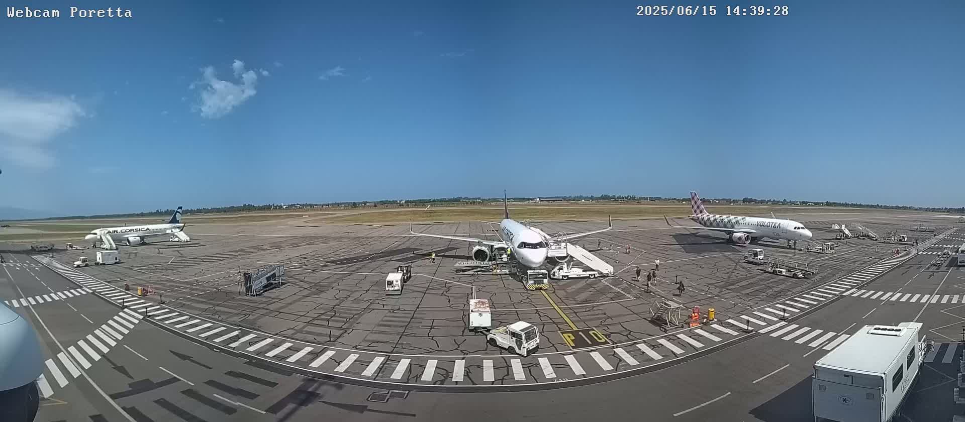Three airplanes are parked on a sunny tarmac at an airport, with ground support equipment surrounding them.