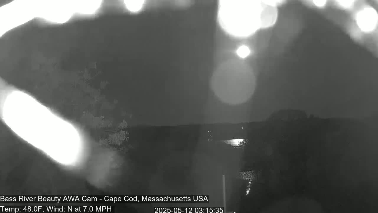 A nighttime view of a dark body of water, with a  north wind at 7.0 mph and a temperature of 48 degrees Fahrenheit.