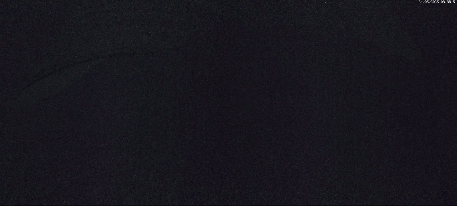 A dark, grainy image shows a mostly uniform black surface.