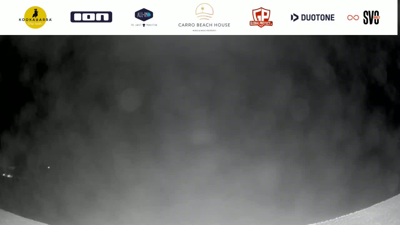 A blurry, dark gray, nighttime image shows a hazy or foggy scene.