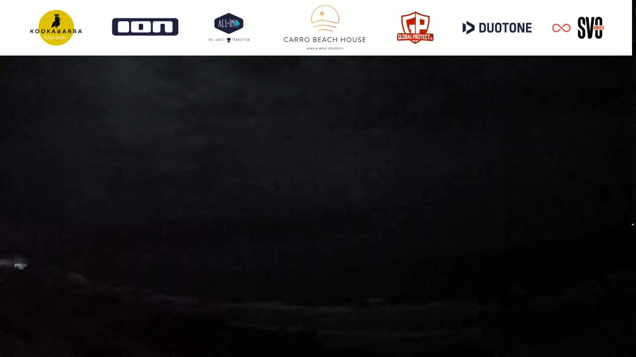 A dark, nighttime scene shows a very low-light view of what appears to be an ocean or sea under a dark, possibly stormy sky.