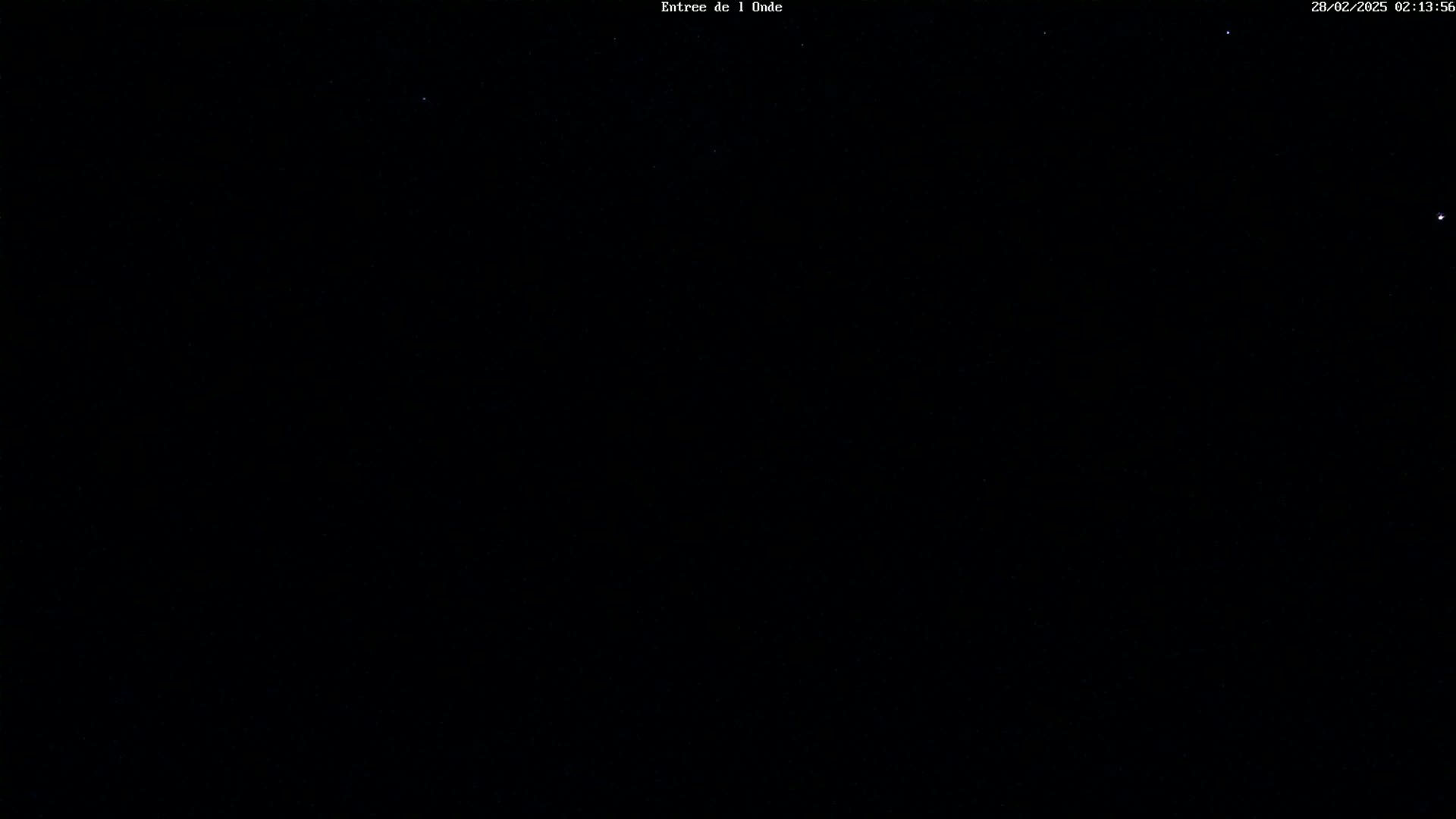 A nighttime image shows a dark sky speckled with faint stars.