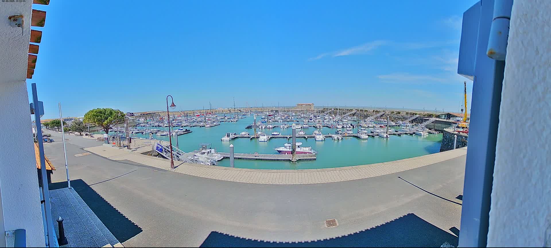 A marina filled with numerous boats under a clear, sunny sky.