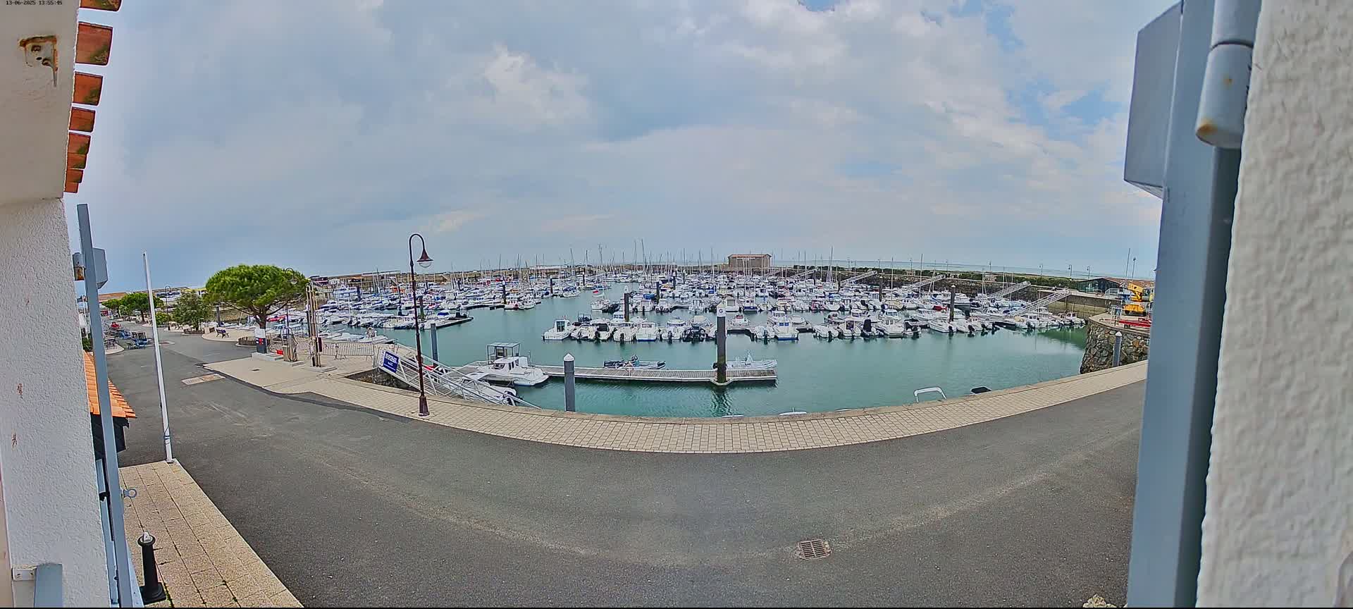 A marina filled with numerous boats is seen on an overcast day.