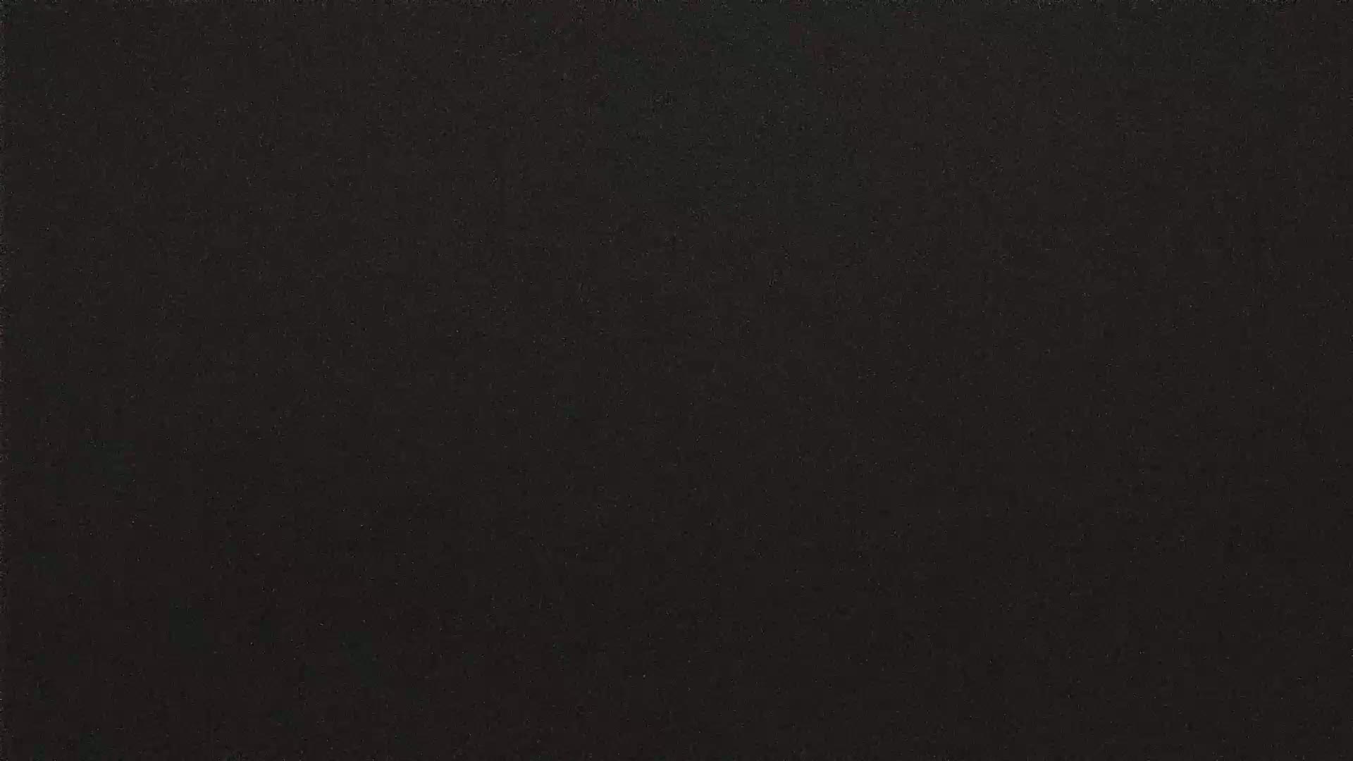 The image shows a dark gray or black textured surface.