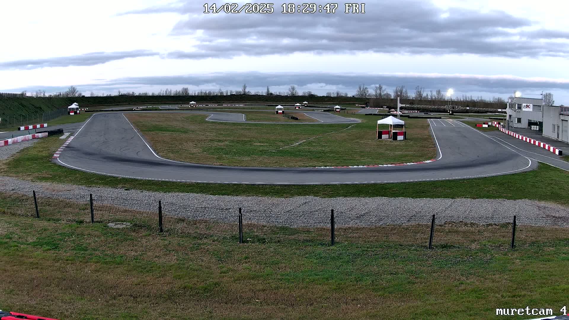 An empty outdoor go-kart track on an overcast day.