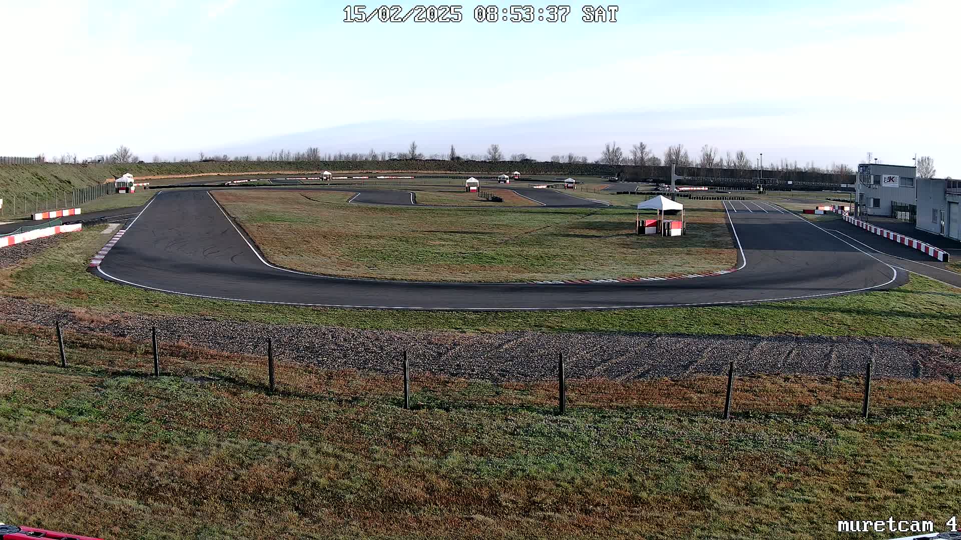 An outdoor go-kart track on a clear, slightly frosty morning.