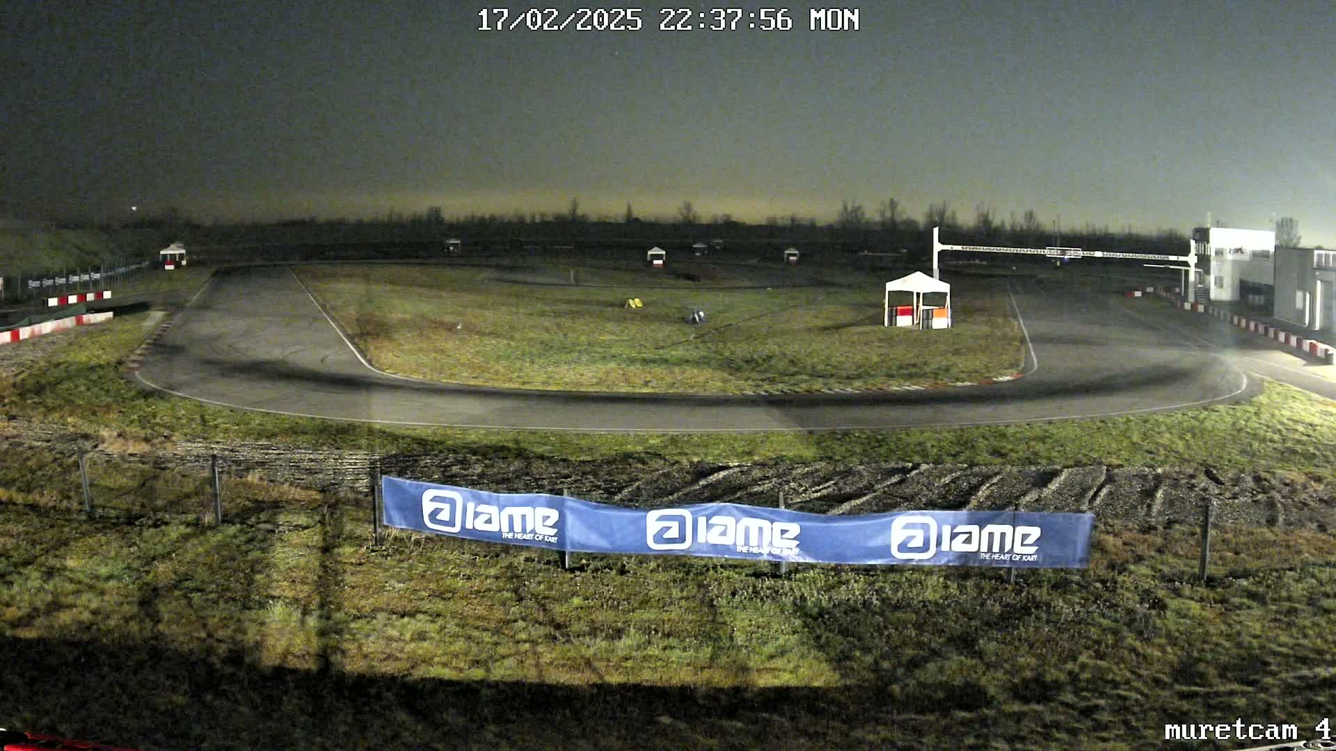 An empty go-kart track at night, under a dark sky.