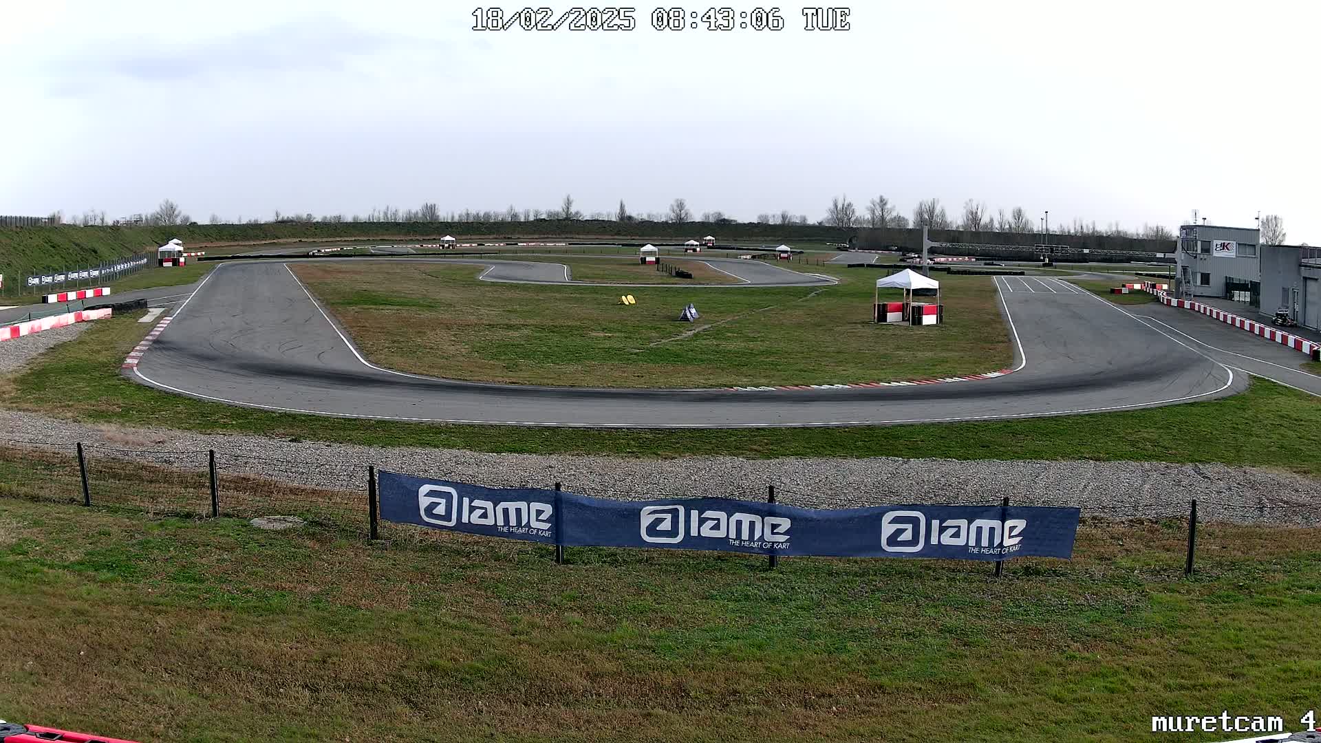 An outdoor go-kart track on an overcast day.