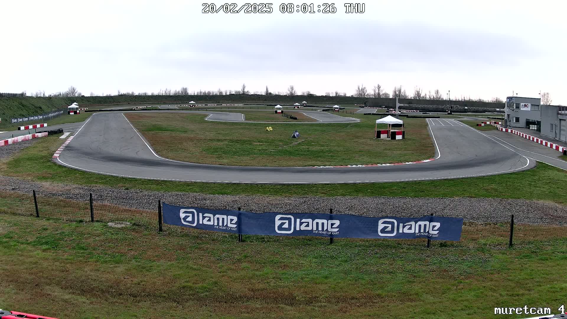 An empty go-kart track on an overcast day.