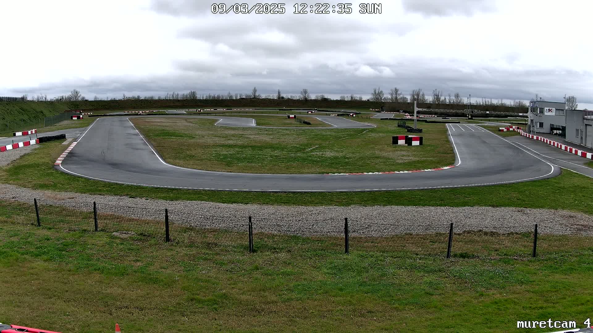 An outdoor go-kart track on an overcast day.