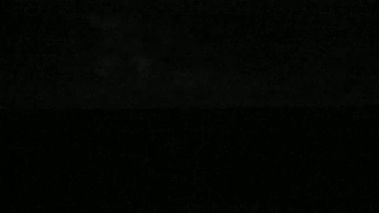 The image is entirely black, possibly depicting a nighttime scene.