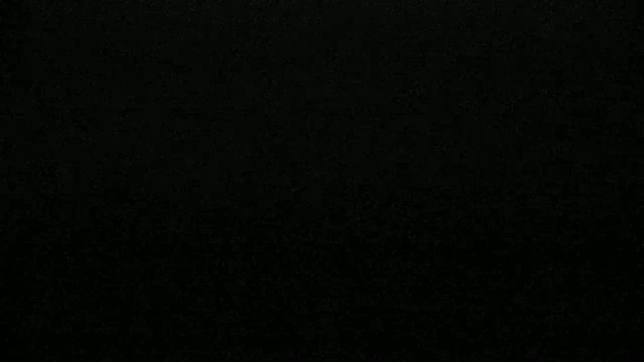 The image is a solid black field with a slightly grainy texture.