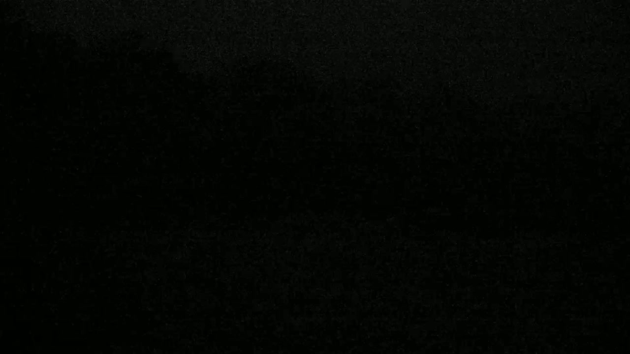 The image is a uniformly dark, textured black surface.