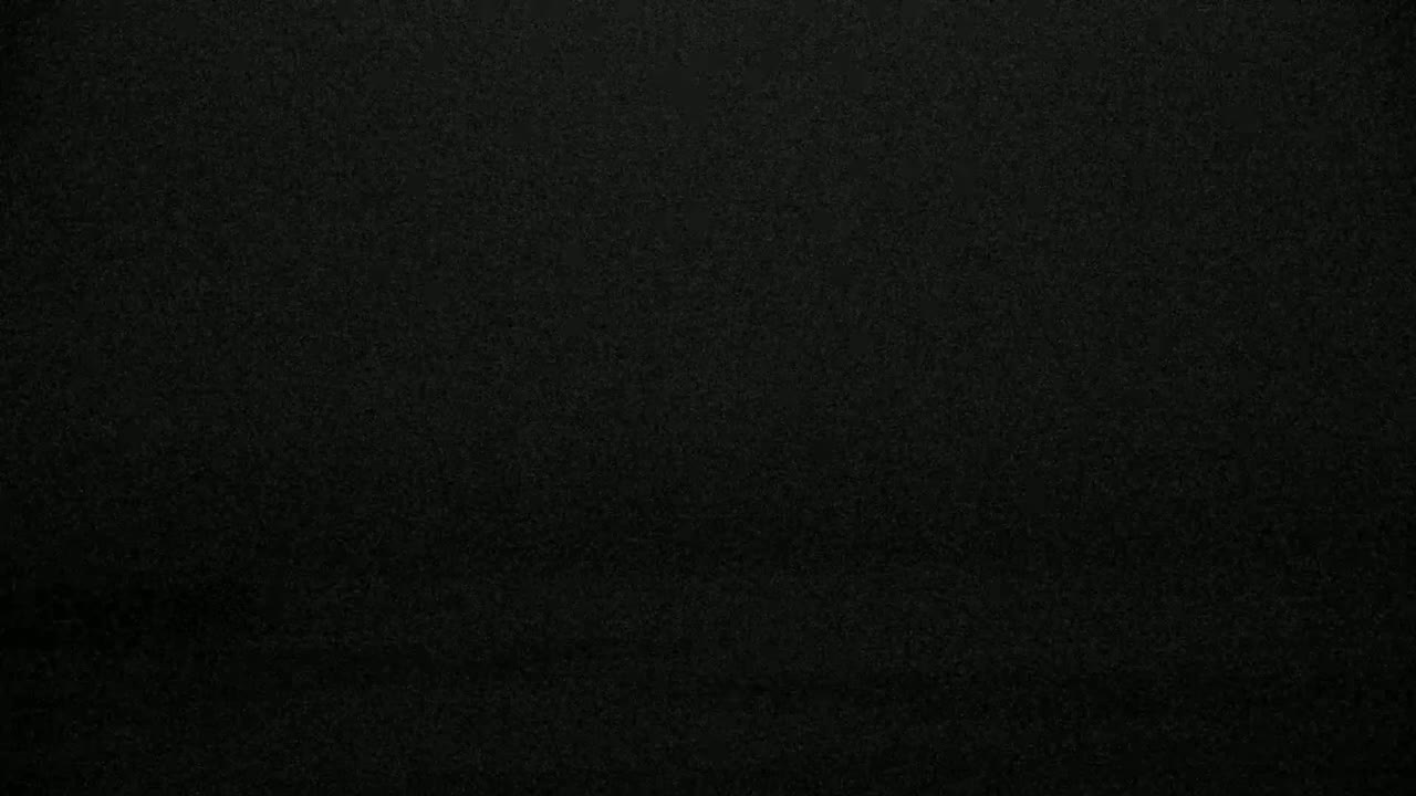 The image shows a dark gray or black textured surface.