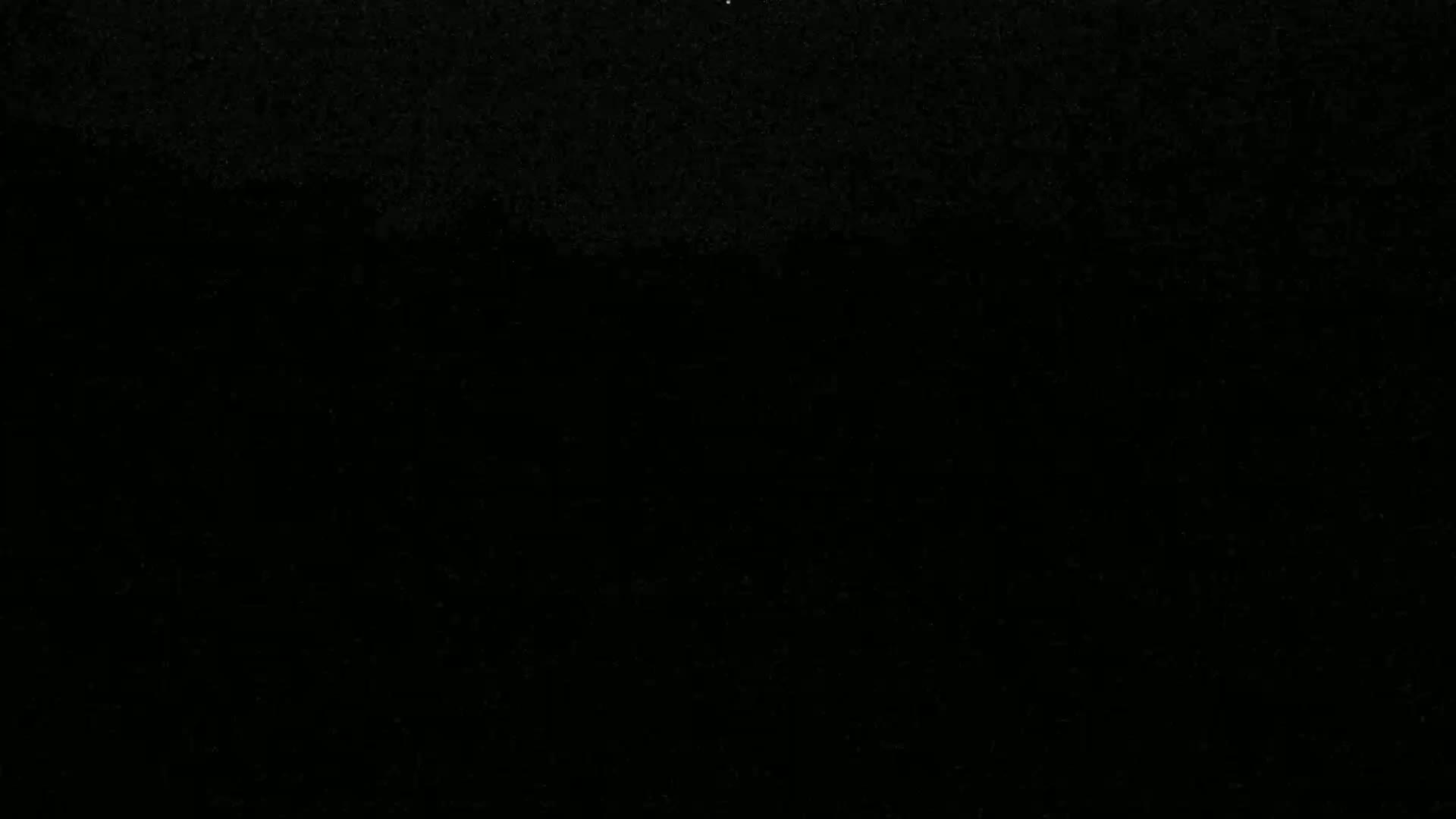 The image is a completely black field with a slightly grainy texture.
