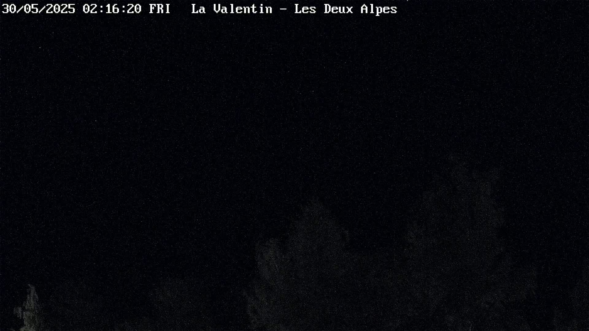 A dark image shows a mostly black night sky with a faint, blurry suggestion of trees or mountains at the bottom.