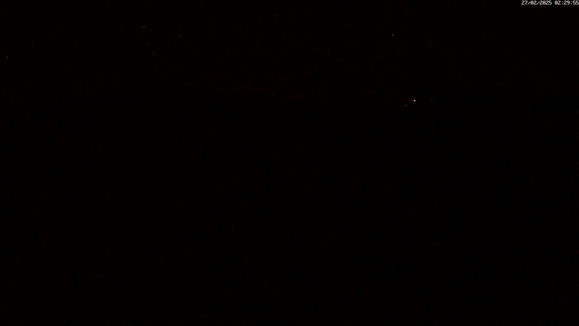 A dark night sky shows a few faint stars.