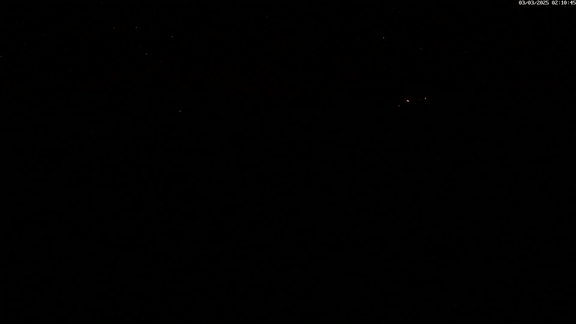 A dark night sky shows a few faint stars.