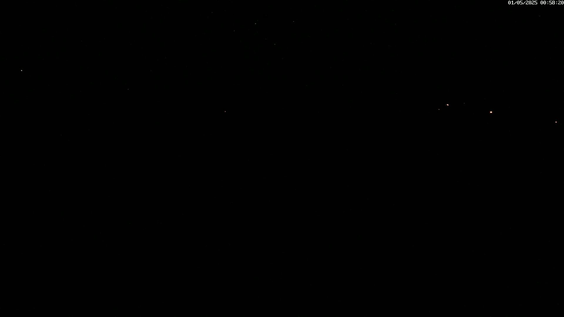 A nighttime, dark sky shows a few faint stars.