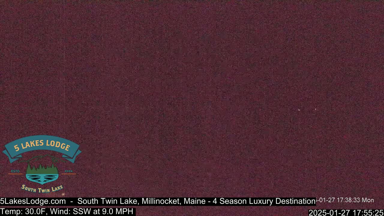 A dark purplish-brown screen displays a static image.
