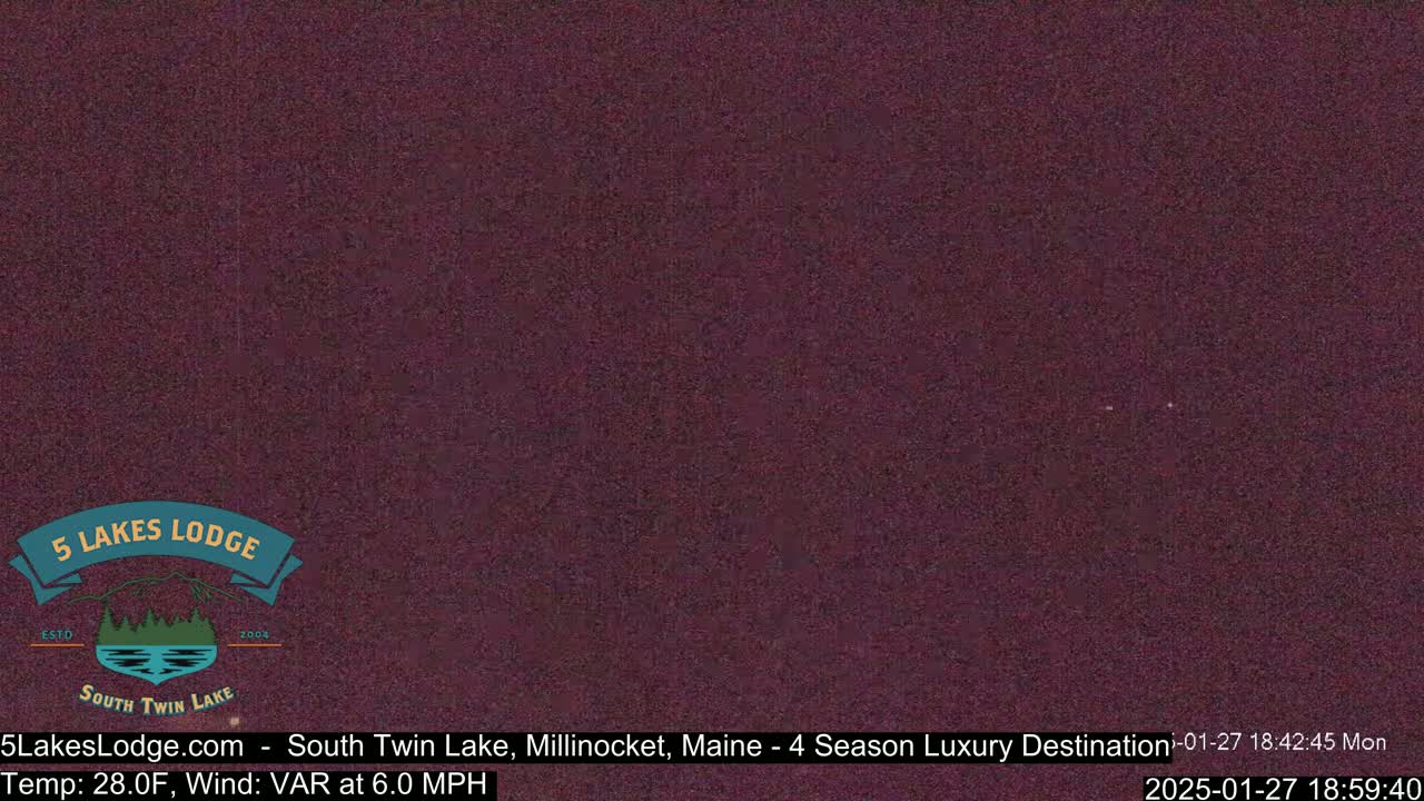 A dark purple, blurry image of nighttime outdoors, with a temperature of 28 degrees Fahrenheit and a variable wind of 6 mph.