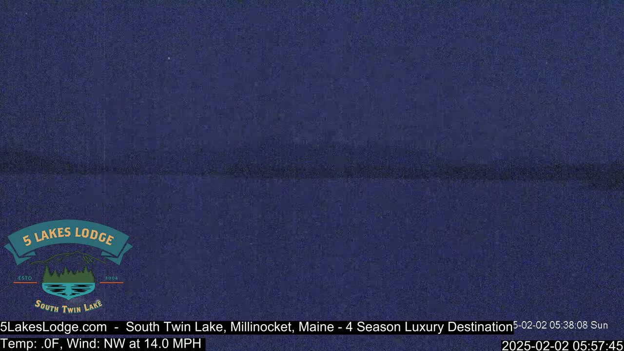 A dark blue, nighttime scene of a lake under a clear sky with a northwest wind at 14 mph and a temperature of 0°F.