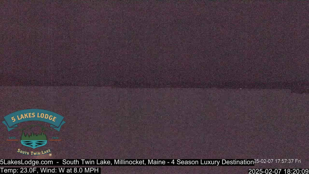 A dark, blurry image of a body of water at night, with a slight wind.