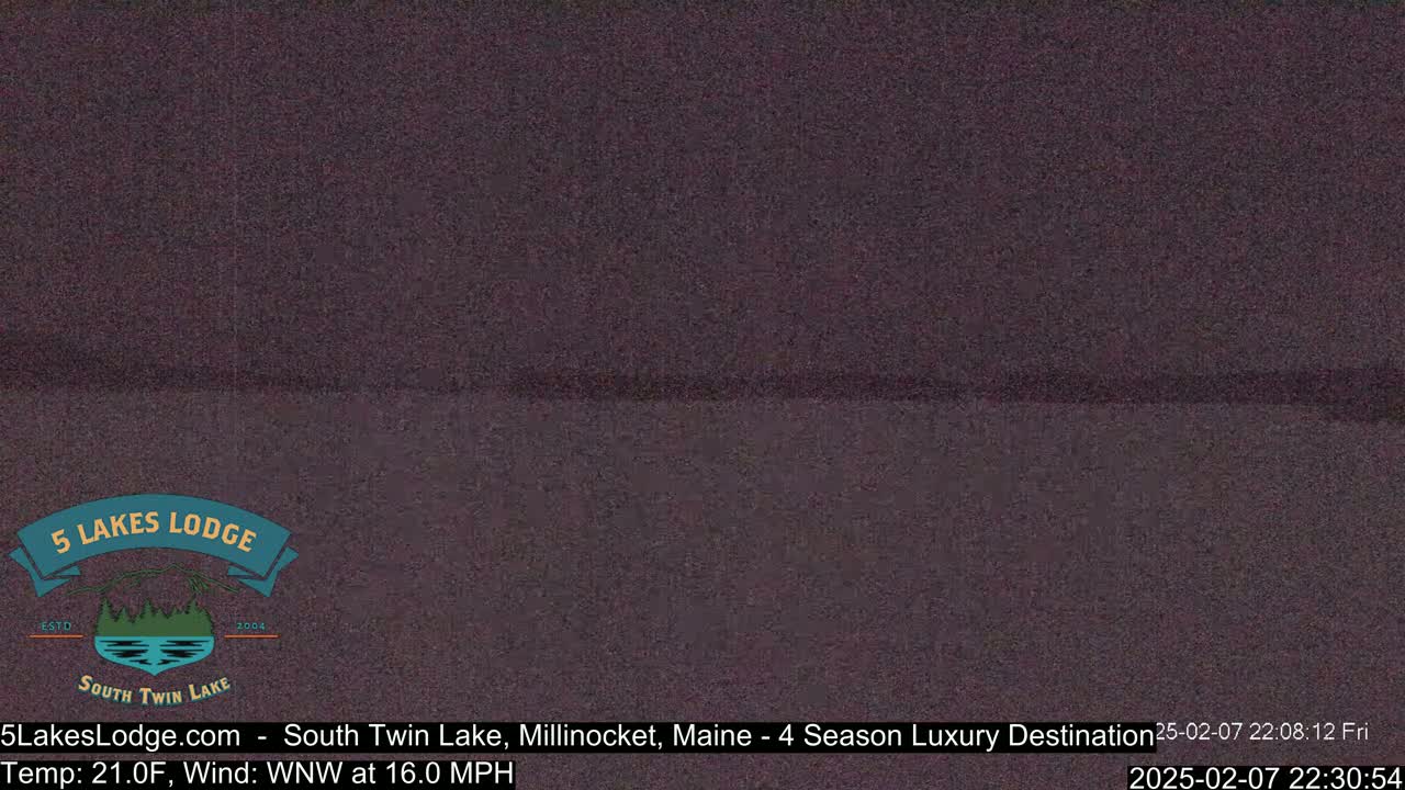 A dark, blurry image of a body of water at night, under a dark sky with a 21°F temperature and 16 mph wind from the west-northwest.