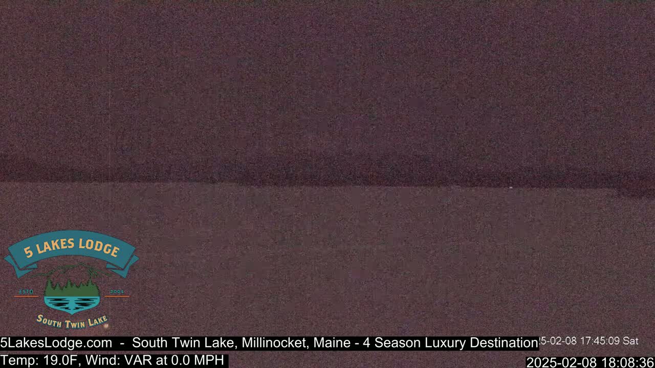 A dark, blurry image of a lake at night with a calm surface and 19°F temperature.