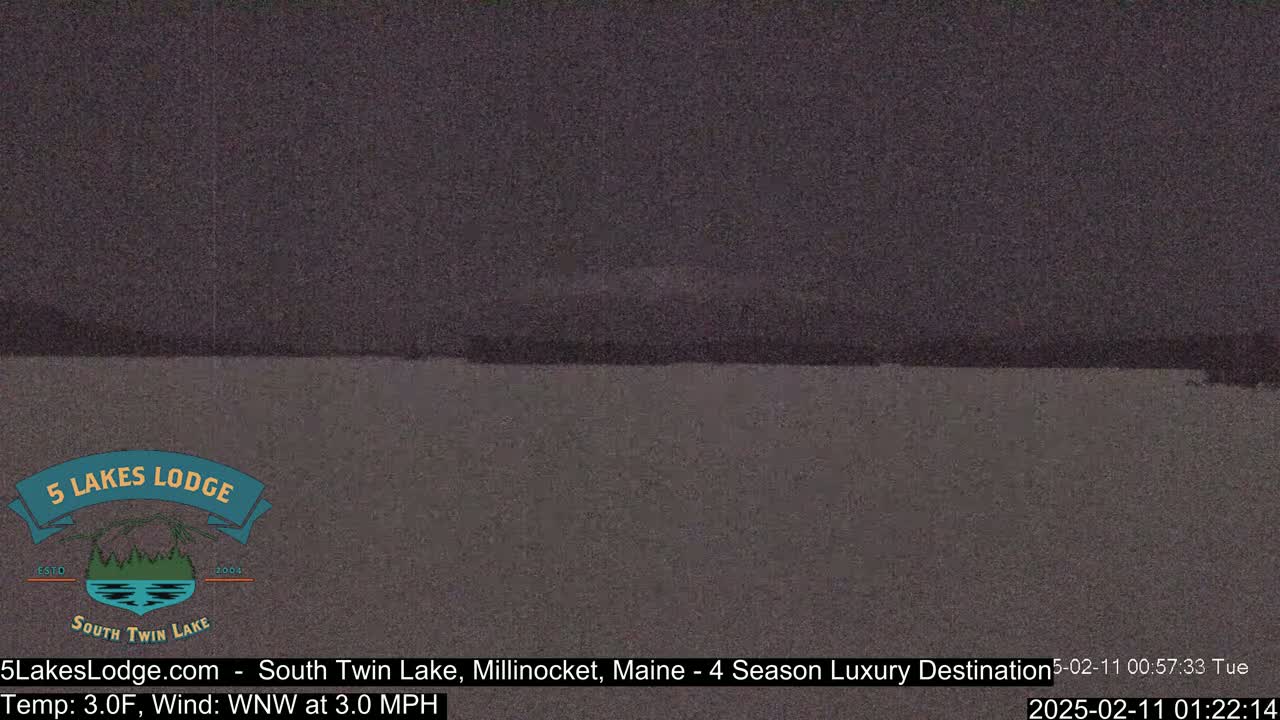 A dark, still body of water is visible under a dark sky.