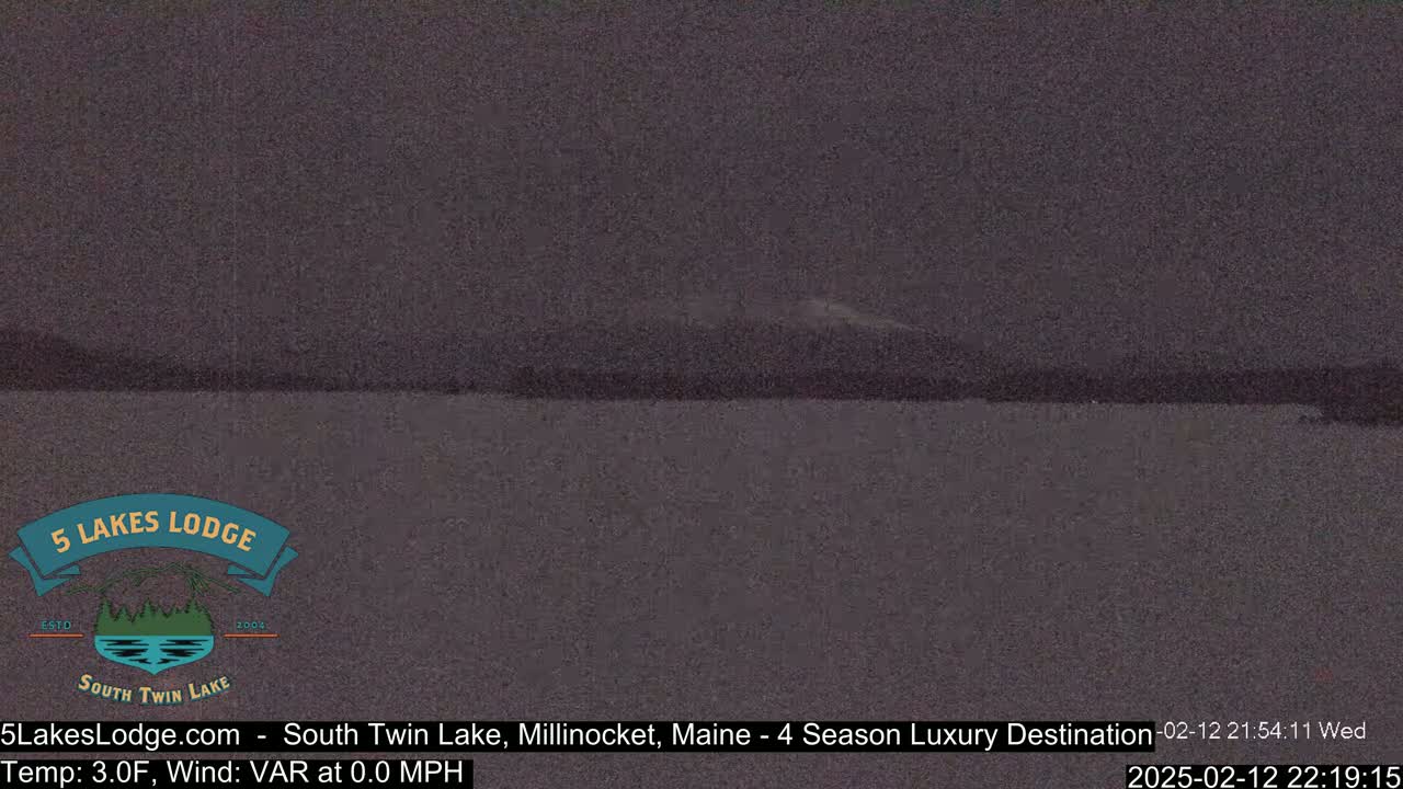 A dark, still body of water is visible under a night sky.