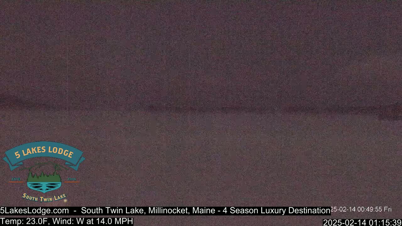 A dark, blurry image of an outdoor scene with a 23°F temperature and a 14 mph west wind.