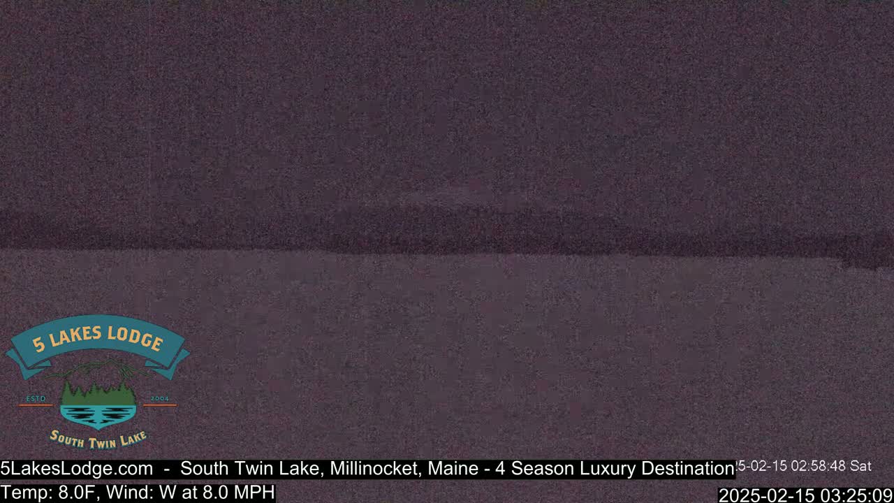 A dark, blurry image shows a body of water under a night sky.