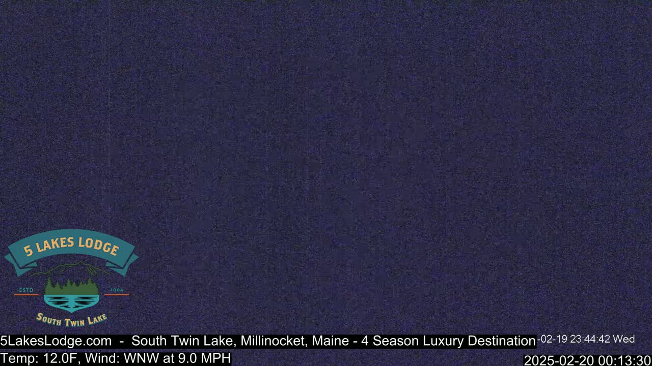 A dark blue, grainy image shows a mostly featureless night scene.