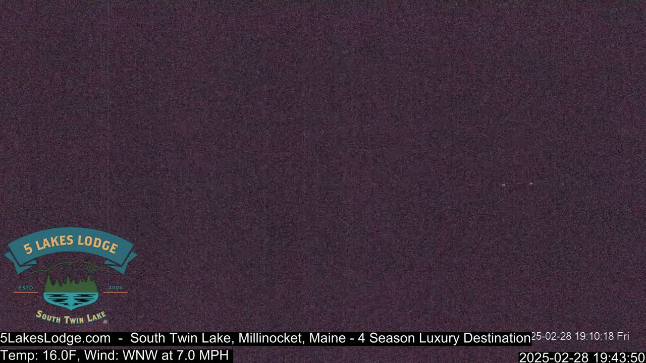 A dark, nighttime image shows a mostly featureless sky with a few faint lights.