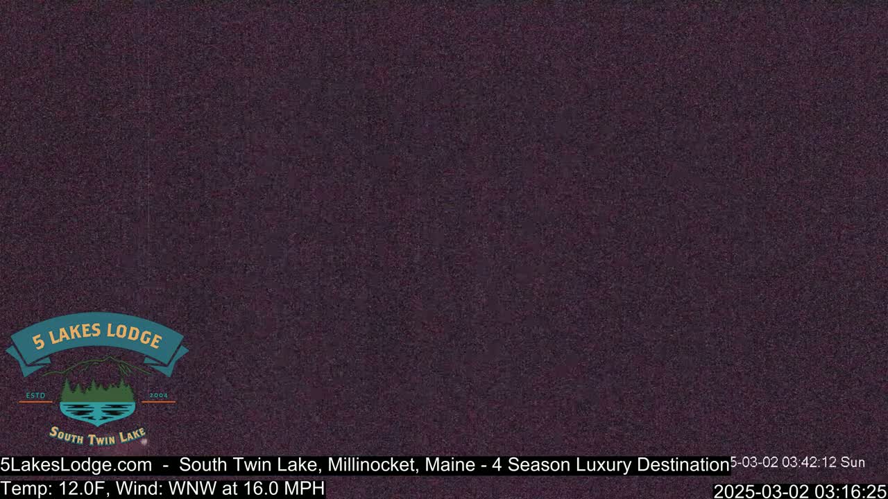 A dark, grainy image shows a mostly featureless, dark purplish-brown expanse under a clear sky.