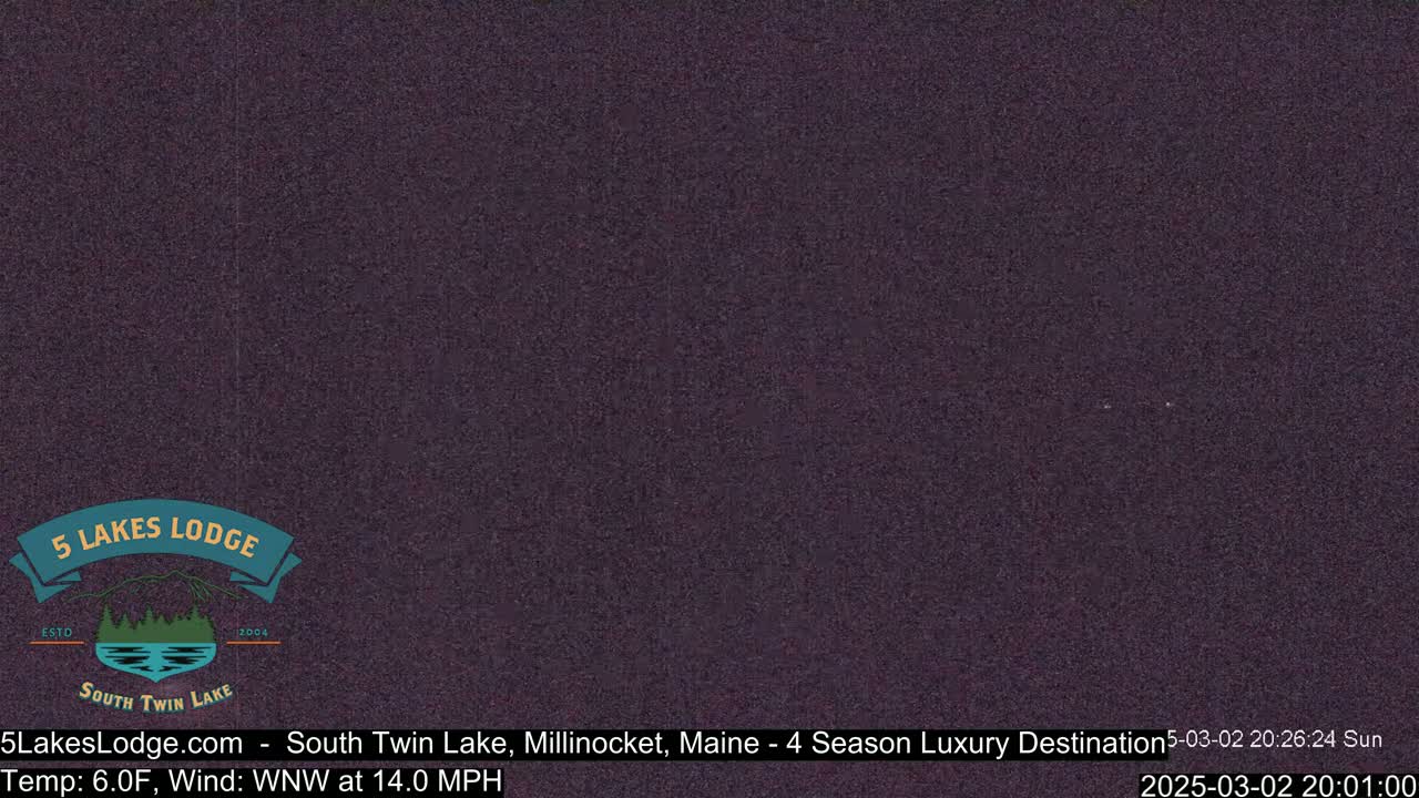 A dark, grainy image shows a night scene with a 6°F temperature and a 14 mph wind from the west-northwest.