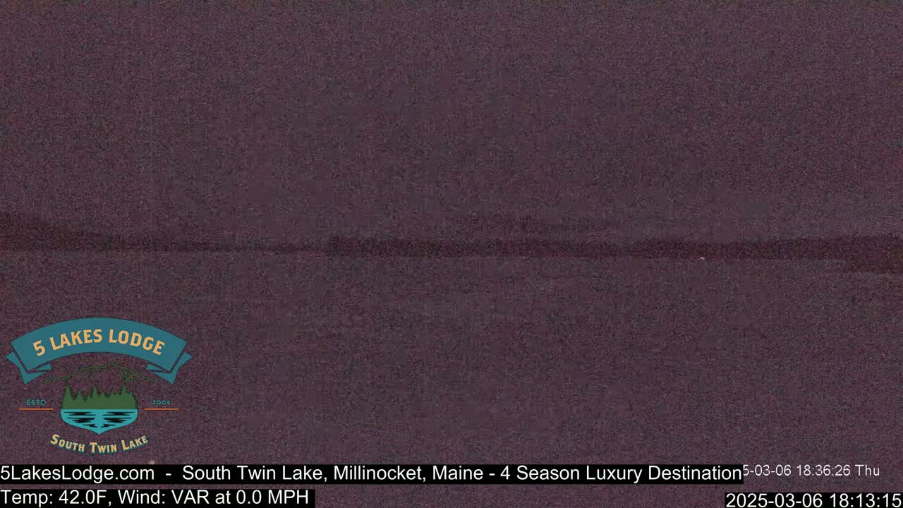 A dark, still body of water is visible under a twilight sky.